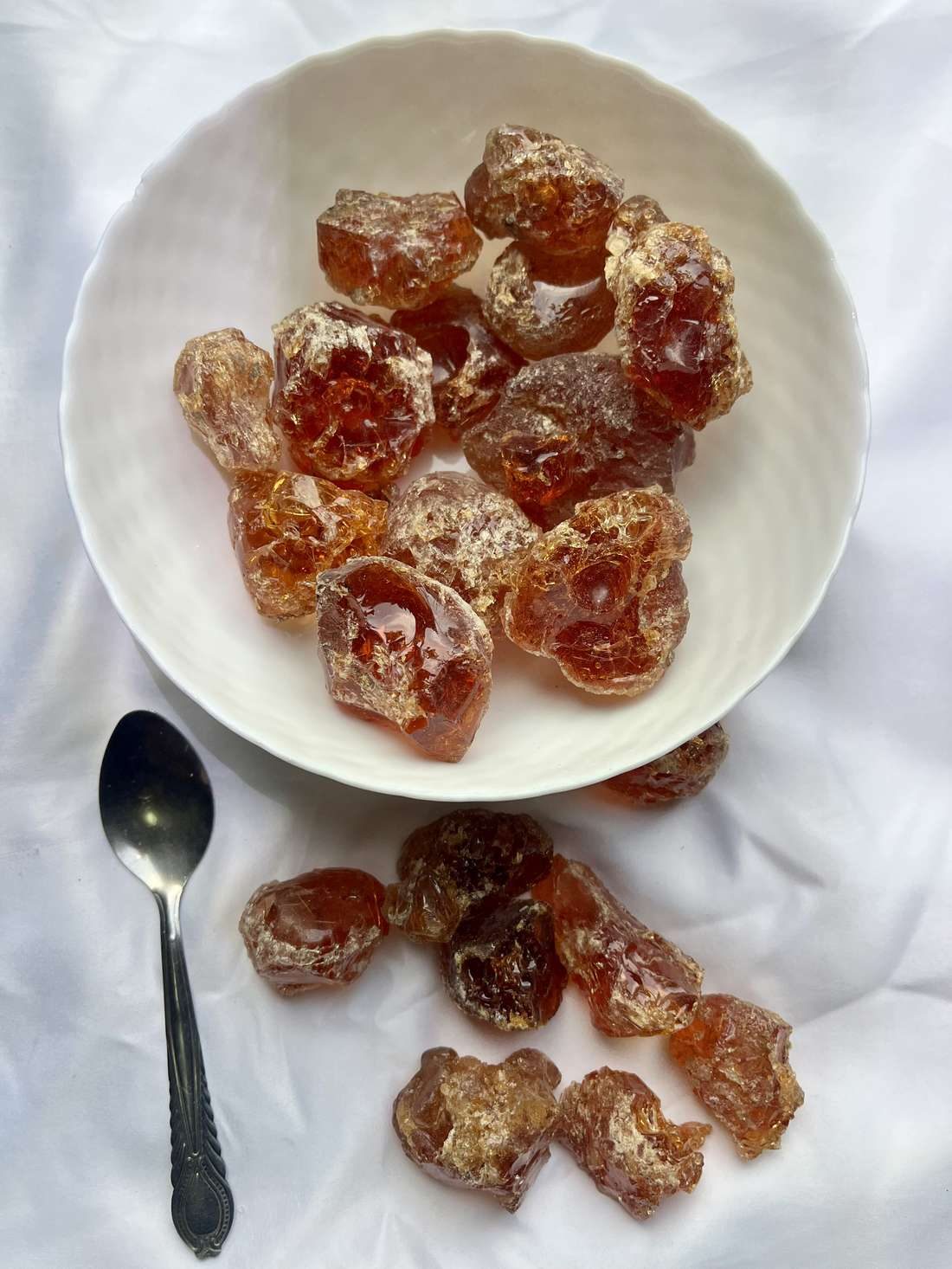 Close-up of glossy amber Grade 1 Acacia senegal gum arabic nodules